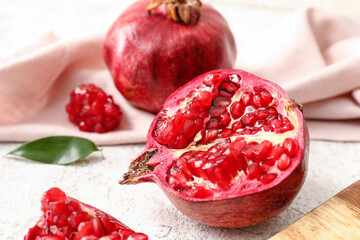 Ripe delicious pomegranate on light background, closeup