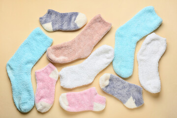 Many different socks on color background