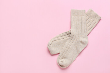 Pair of socks on pink background