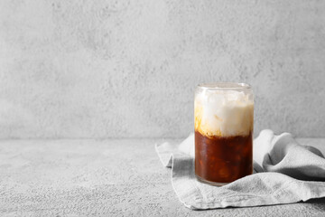 Glass of White Russian cocktail on light background