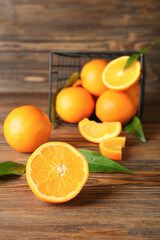 Fresh juicy oranges on wooden background