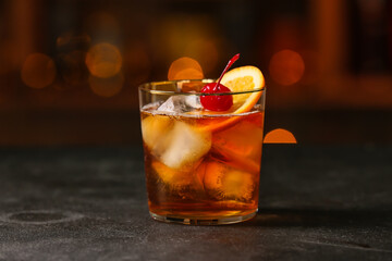 Glass of tasty Old Fashioned Cocktail on table in bar