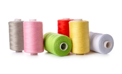 Different sewing thread spools on white background