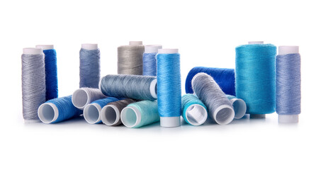Different sewing thread spools on white background