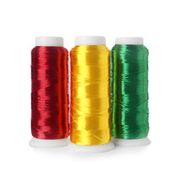 Different sewing thread spools on white background