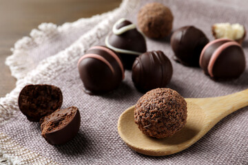 Many different delicious chocolate truffles on kitchen towel