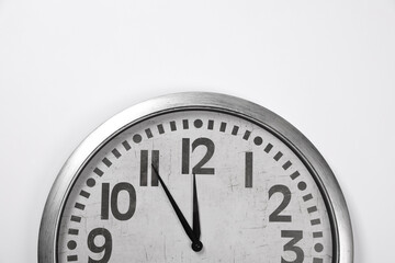 Fototapeta na wymiar Stylish analog clock hanging on white wall, space for text. New Year countdown
