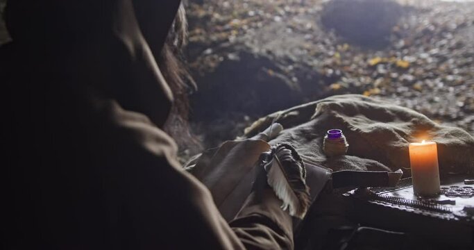 Senior wise man writing with quill