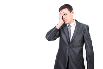 Tired man in suit suffering from headache