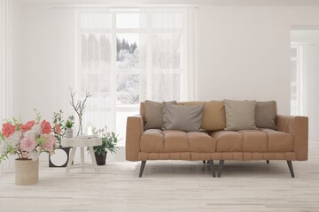 Fototapeta premium White living room with sofa and winter landscape in window. Scandinavian interior design. 3D illustration