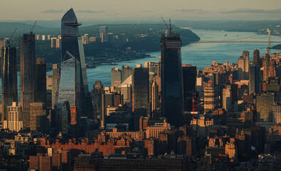 Sunset in New York, view from above. Amazing sun light over Manhattan and Hudson river during a sunset, images taken from the highest building in the city. Impressive architecture. Landmark of America