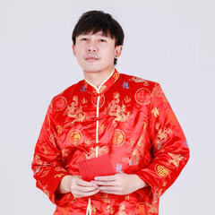 Lucky chinese man on traditional mandarin shirt smile and delight for getting cultural cash gift in...
