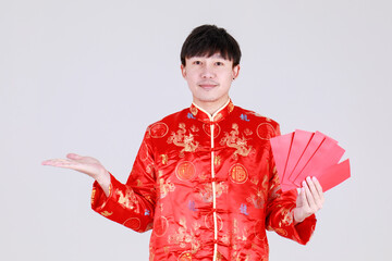 Lucky chinese man on traditional mandarin shirt smile and delight for getting cultural cash gift in...