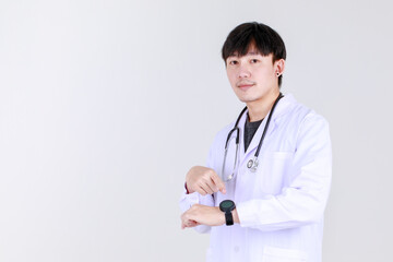 Smart young chinese physician on medical professional gown with stethoscope smile with confident and happy to success disease treatment with safe. Doctor pleased and ensure health care.