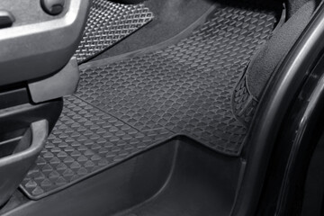 Black rubber car floor mat in auto