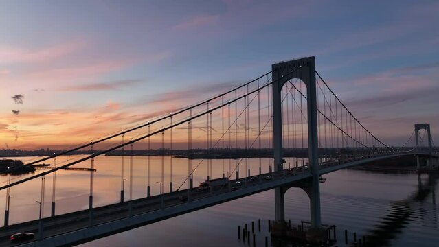 later flying around Bronx Whitestone Bridge revealing sunset over NYC