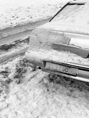 Car under the snow, black and white photo
