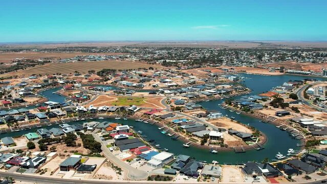 Aerial orbiting view over Wallaroo Marina, picturesque Water canal shape, Australia