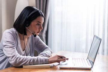 Asian young homeschool woman learning virtual internet online class.