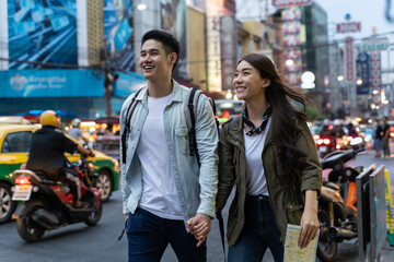 Asian attractive couple travel in the city for honeymoon trip at night
