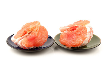 peeled pomelo pieces isolated on white background. Tasty fresh fruit eating concept