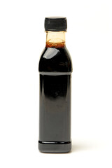 Bottle of soy sauce on white background