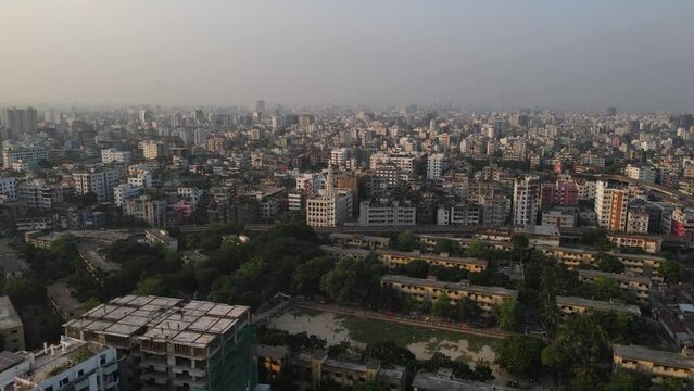 haze over Dhaka slums apartment buildings (Capital of Bangladesh) city in South Asia aerial footage