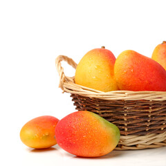 basket of mangoes on white.