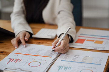 Businesswoman analyzing financial graph at her workplace.