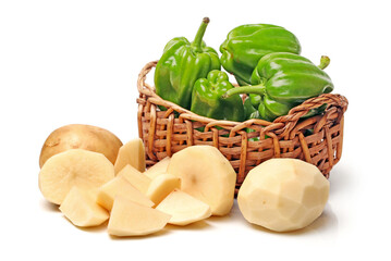 basket with vegetables .potato with green bell pepper on  
white background .