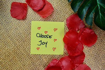 Choose Joy write on sticky notes isolated on Wooden Table.