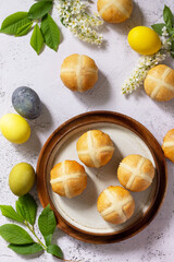 Easter baking. Homemade Easter traditional hot cross buns on a gray stone tabletop. Top view flat lay background.