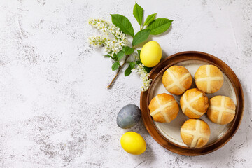 Easter baking. Homemade Easter traditional hot cross buns on a gray stone tabletop. Top view flat lay background. Copy space.