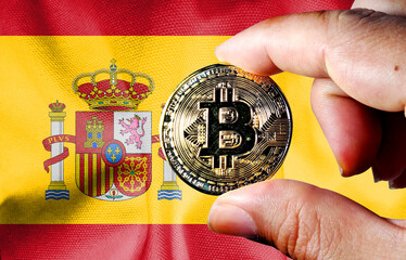 Hold a physical version of Bitcoin (the new virtual currency) and the Spanish flag. Concept map of...