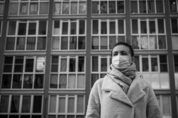 Fototapeta na wymiar Shot of a girl in a mask, on the street. lockdown Covid-19 pandemic.
