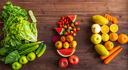 Top view closeup studio shot group assortment of green red and orange colors healthy fresh raw diet ingredient delicious tasty vegetables and fruits placed on old wooden table background in kitchen