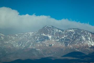 snowy mountain valley with a cloudy sky
