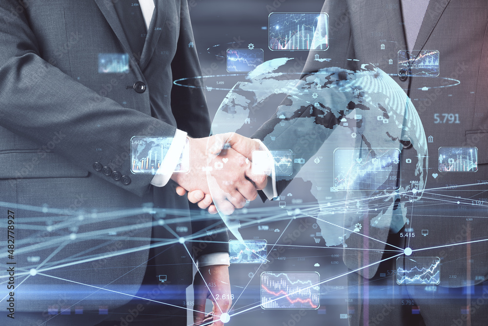 Poster businessmen shaking hands with creative glowing globe hologram with forex charts and graphs on blurr