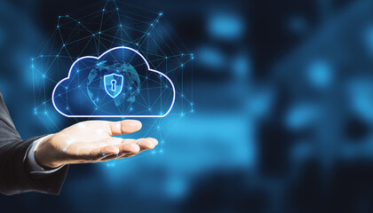 Close up of businessman hand holding abstract glowing cloud hologram with globe and safety icons, polygonal mesh on bokeh interior background with mock up place. 
