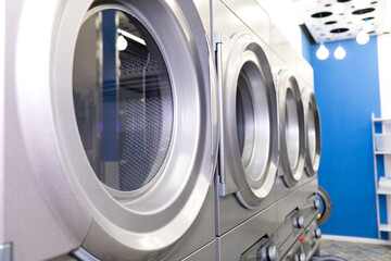 A number of industrial washing machines in the laundry. Laundry at the house.