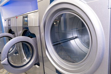 A number of industrial washing machines in the laundry. Laundry at the house.