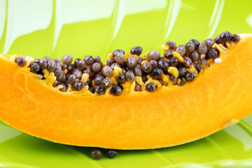 papaya on green plate.
