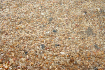 Close up of stones and marble. Smooth and polished. Pebble on shingle beach. Colorful small pebble and stone texture. Pebble background. Gravel pebble or rock fragments, beach sand