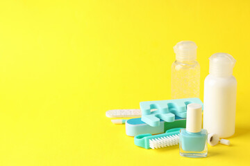 Concept of nail care with manicure accessories on yellow background