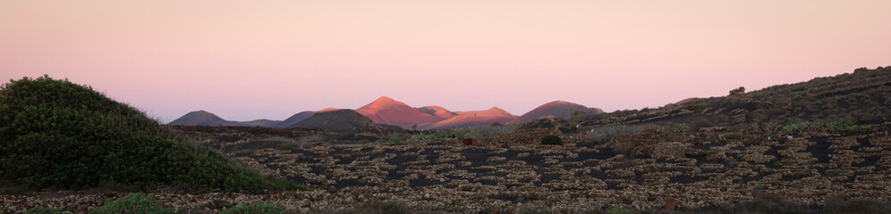 Fototapeta na wymiar Volcanic landscape with volcanos at sunset tones