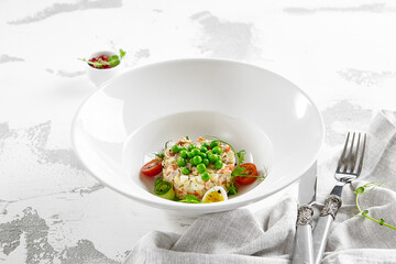 Original russian potato salad with green peas and mayonnaise. Russian christmas menu. Olivier salad with boiled potatoes, carrots, eggs, peas and meat with mayo dressing.  Traditional New year dish.