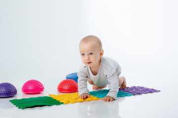 a baby boy with an orthopedic mat and a hemisphere is isolated on a white background