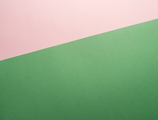 Paper background of two colors green and pink.
