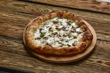 Appetizing pizza with mushrooms on a wooden tray