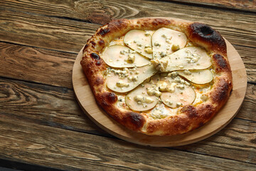Pizza with pears and Gorgonzola cheese, italian pizza with pear and blue cheese on a wooden...